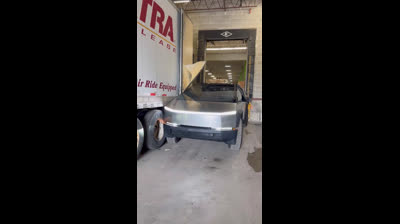 A truck destroys the side of a Tesla Cybertruck